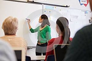 Teacher in front of students at an adult education class photo