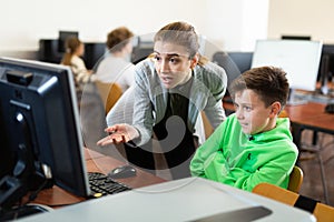 Teacher frustrated by misbehavior of her pupil during computer science lesson