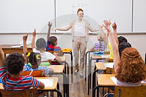 Teacher giving a mathematics lesson in classroom
