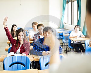 Teacher with group of college students in classroom