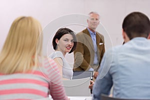 Teacher with a group of hi school students in classroom