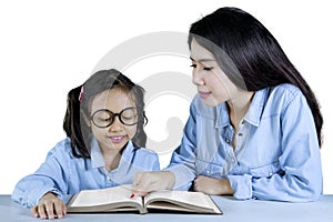 Teacher guides her student to read