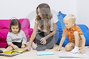 Teacher guiding her students to study in the class