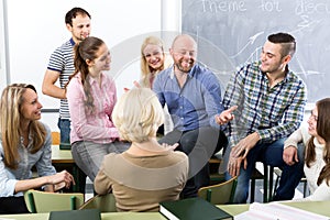 Teacher and happy adult students