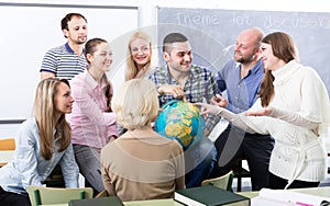 Teacher and happy adult students