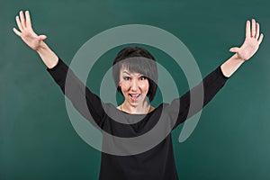 Teacher having idea and posing by chalk Board, learning concept, green background, Studio shot