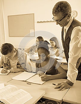 Teacher helping African-American schoolgirl