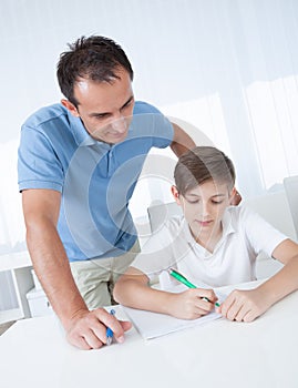 Teacher Helping Boy With Exercise