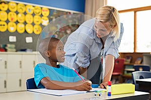 Teacher helping boy with homework