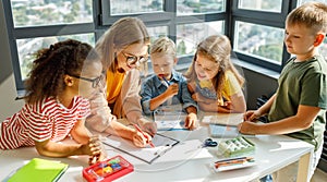 Teacher helping children with schoolwork