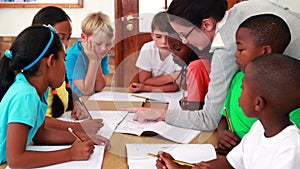 Teacher helping her pupils during class