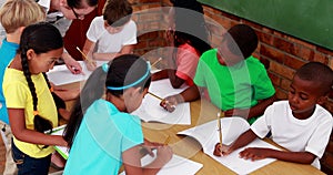 Teacher helping her pupils during class