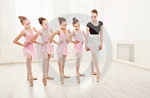 Teacher helping her students during dance class