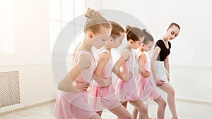 Teacher helping her students during dance class