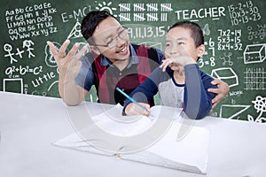 Teacher helping his student to count