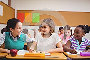 Teacher helping pupils during class