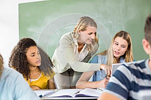 Teacher helping student in class