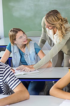 Teacher helping student in class