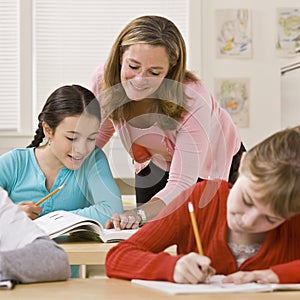 Teacher helping student in classroom