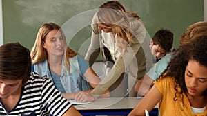 Teacher helping student with paper