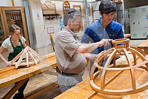 Teacher helping a student in a woodwork class