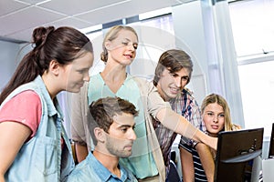 Teacher helping students in her class