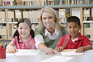 Teacher helping students learn writing skills