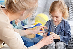 Teacher helping with toy