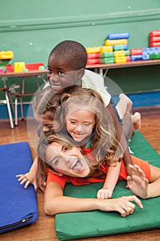 Teacher with hers students playing on the floor