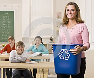 Teacher holding recycling bin