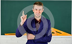 Teacher introduced to class young man at chalkboard, education reforms concept