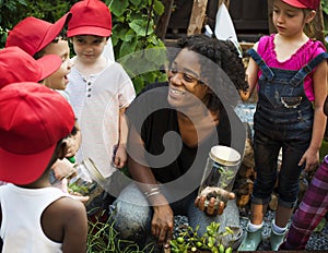 Teacher and kids having fun learning about plants