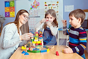 Teacher and kids Together with colorful building toy blocks