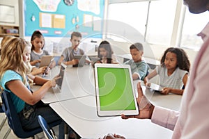 Teacher and kids using tablets in elementary school lesson