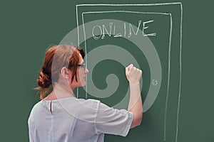 A teacher knocks on the door with online education written on the blackboard. Problems of online learning in quarantine due to the