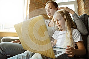 Teacher and little girl, or mom and daughter. Homeschooling concept