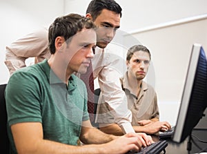 Teacher and mature student in computer room