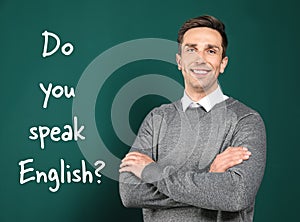 Teacher near chalkboard with question DO YOU SPEAK ENGLISH