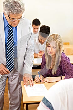 Teacher observes his students photo