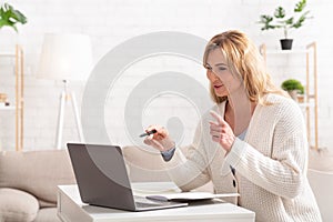 Teacher online. Gesturing by hands woman teaching student on laptop