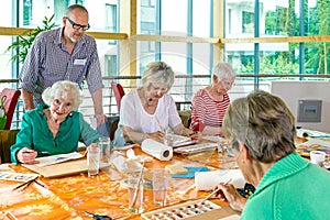 Teacher overseeing students painting in class