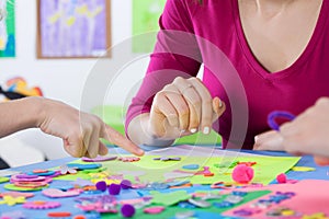 Teacher playing colourful puzzles with kids