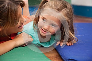 Teacher playing on the floor with a litlle girl