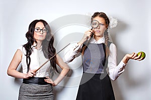 Teacher with pointer. Schoolgirl with magnifying glass and apple