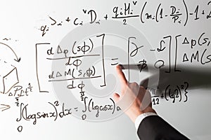 Teacher pointing finger on equality math symbol on whiteboard. Mathematics and science