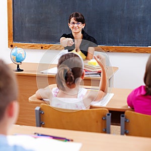 Teacher pointing at schoolgirl