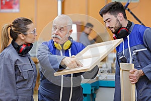 teacher pointing to imperfection on female apprentices creation