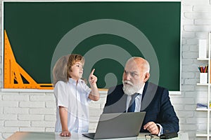 Teacher and pupil in classroom. Education concept. School learning concept. Boy elementary school.