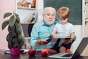 Teacher and pupil learning together in school. Concept of education and reading. Little ready to study. World teachers