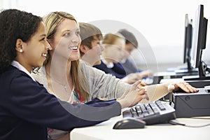 Teacher And Pupil In School Computer Class